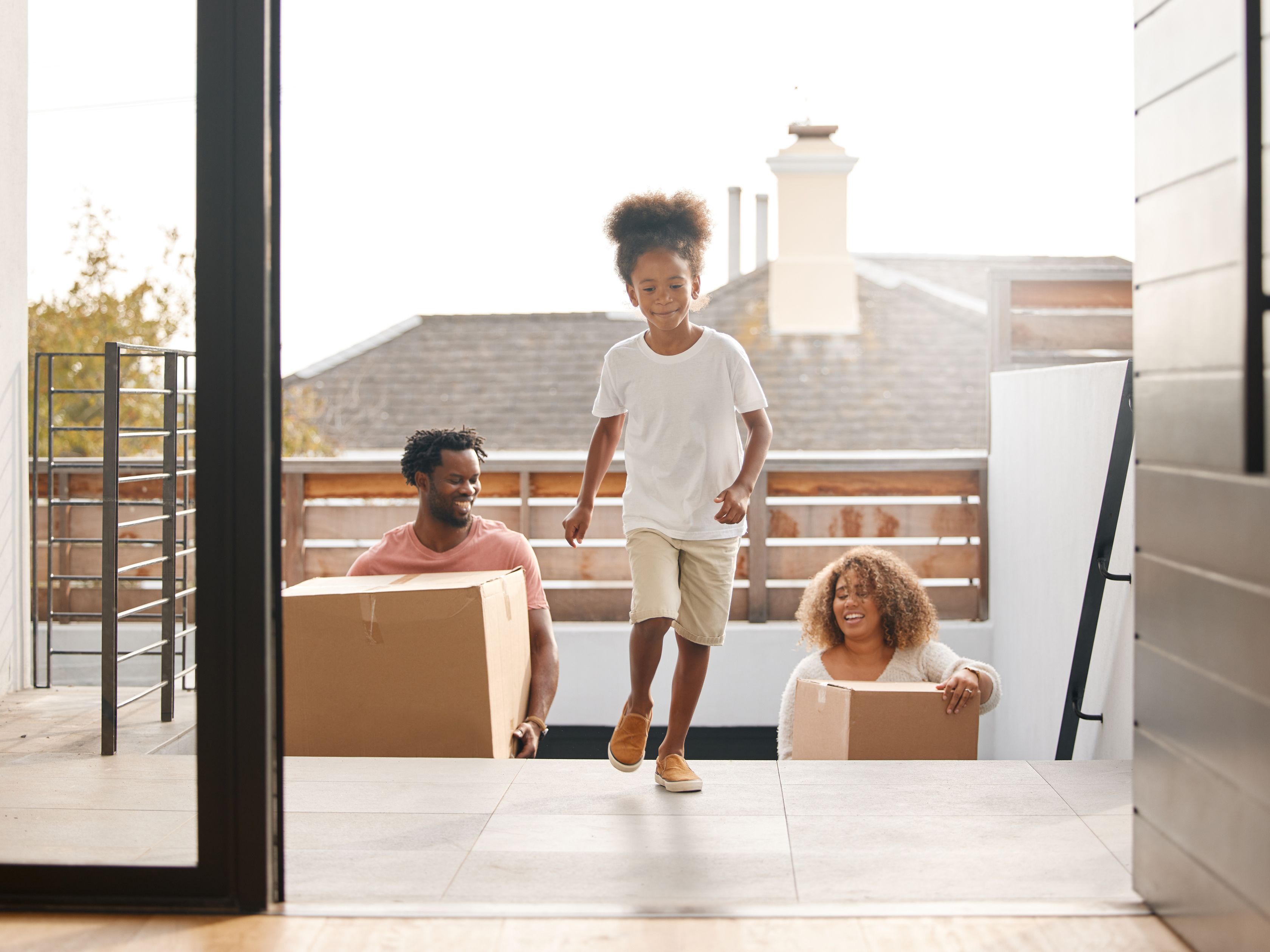 A family of four walks into their newly built home.